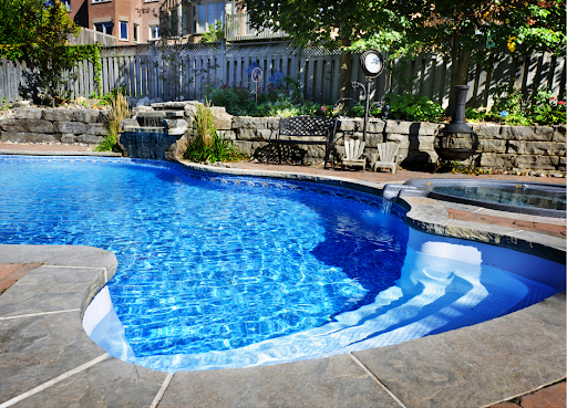 fiberglass pool and spa with professionally landscaped backyard space
